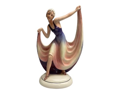 Early 20th century Hertwig Katzh�tte figure of an Art Deco lady dancing, wearing a pink and purple dress, stood upon on a dom