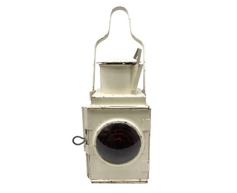 White painted railway lamp, the hinged door with red bullseye glass lens, with tall swing carrying handle, H52cm incl handle