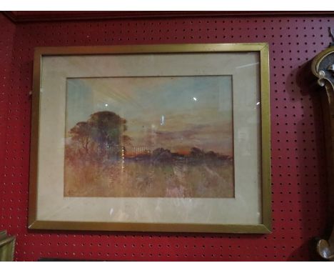 HY WOODS: A framed and glazed watercolour of a view through a meadow to buildings in the distance, 26cm x 37cm, foxing to pai