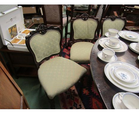 A set of six rosewood bobbin turned dining chairs with carved floral backrests 