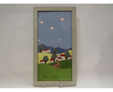 A painted and framed tile wall hanging of a Spanish scene