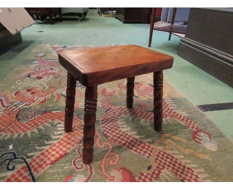 An early 19th Century fruitwood stool on bobbin turned legs, 26cm tall
