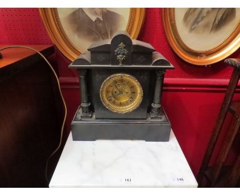 A slate mantel clock of architectural form with brass Roman numerated dial 