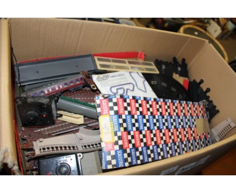 A box of various Scalextric and model railway