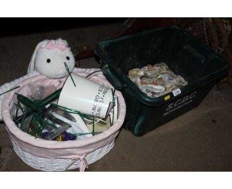 A box of various shells and stone together with a basket of gardening tools