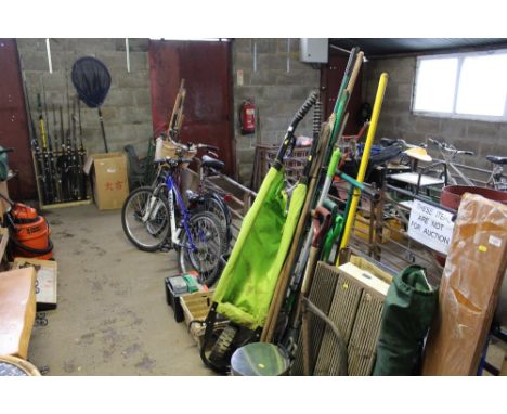 A folding garden wheelbarrow and a quantity of long handled gardening tools