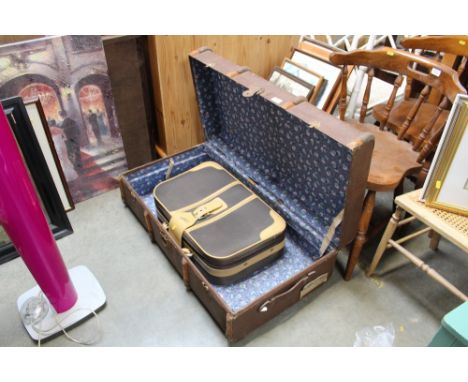 A wood and metal bound travelling trunk and a suitcase