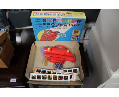 A Give.A.Show projector with original box and slides