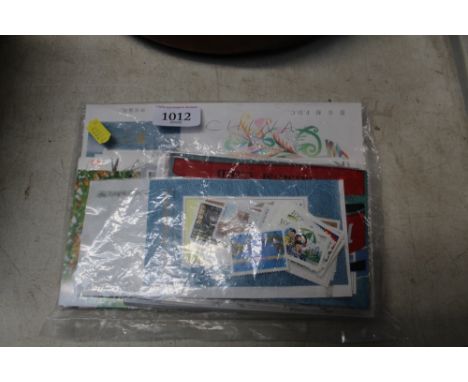 A collection of Chinese stamps and postcards including First Day Covers, new postcards with printed stamps and a bag of misce