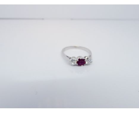 A 3 stone ruby and diamond ring on an 18ct white shank, ring size M