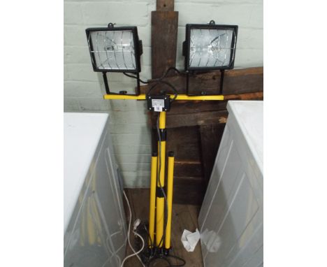 A twin halogen spot light on tri-pod base adjustable stand 