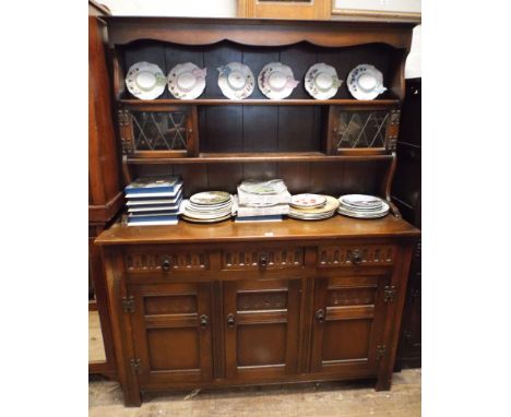 A 4'6 reproduction oak dresser with open shelf and leaded glazed back 