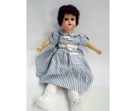 Small German bisque head doll, Welsch numbered 9/0 200 Made in Germany with composition and wooden jointed body.  Height 27cm