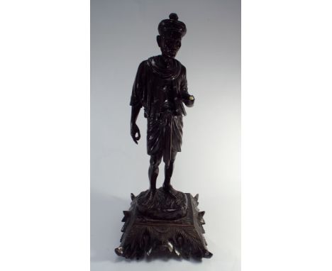 A Malaysian carved wood figure on print 22" tall
