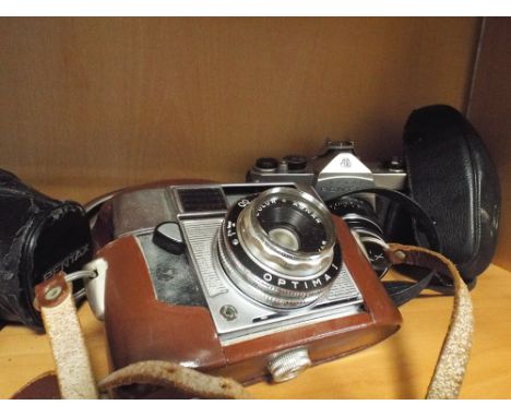 Two Pentax cameras and an Agfa camera      Pentax Spotmatic & Takumar lens, Pemtsax MX & SMC Pentax-M 1.1.7. 50mm lens
