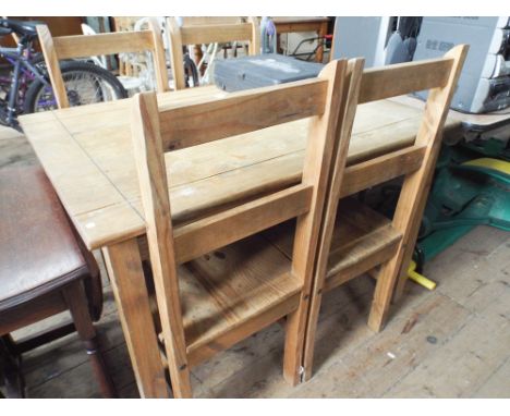 A light wood table with 4 chairs matching