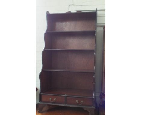 A waterfall effect 3 shelf bookcase with 2 drawers under 
