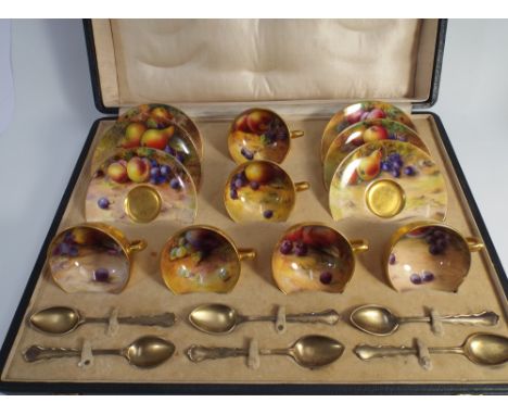 Royal Worcester boxed coffee set comprising six cups, saucers and six hallmarked silver coffee spoons.  Painted with Autumnal