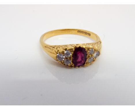 18ct gold ruby and diamond half hoop ring set with an oval ruby flanked each side with 6 brilliant cut diamonds on an 18ct ye