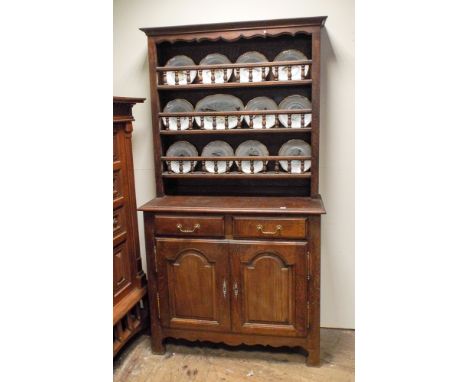 A 3'9 French oak dresser with bobbin turned shelf back, drawers and cupboards under