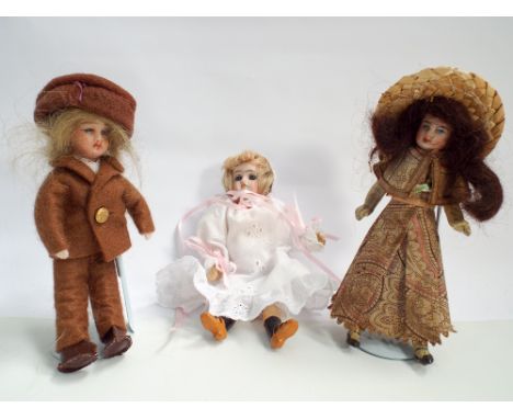 Group of three miniature bisque head dolls 