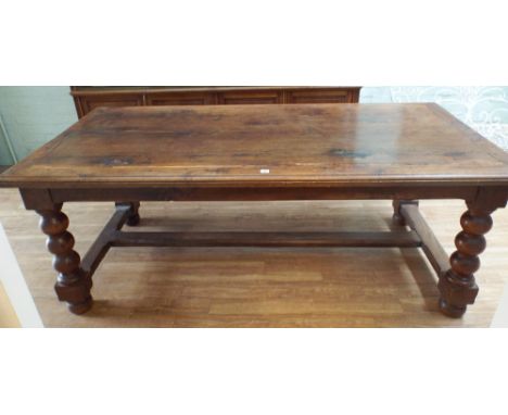 A French 19th century oak table de monastere or refectory table on a bulbous bobbin turned base united by a cross stretcher a