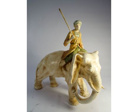 Late 19th century amphora figure of an elephant the beast mounted by a bearded mahout holding a long stick aloft 35cms tall  