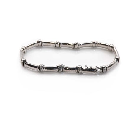 A Continental diamond set bracelet, with articulated oval section bar links with raised bands at each end, and pave set diamo