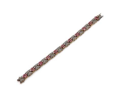 A silver gilt ruby and diamond bracelet,with sets of four baguette cut rubies, all end set in an open quatrefoil. Pairs of cr