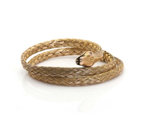 A gold coiled snake flexible bangle,with a coiled woven mesh body. The textured head with ruby eyes and a bifurcated tongue. 
