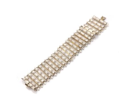 A silver filigree bracelet,designed as a series of half tubular filigree pieces with trefoil ends and small jump ring connect