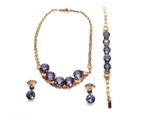 A gold and synthetic colour change sapphire jewellery suite,comprising a fringe necklace, the centrepiece composed of a serie