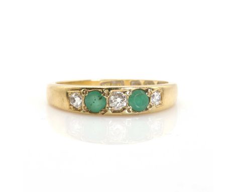 An 18ct gold, five stone emerald and diamond ring,  with three graduated cushion shaped Swiss cut diamonds, grain set between