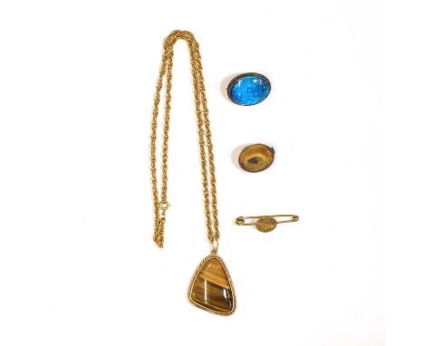 A small group of gold and silver jewellery, comprising a tiger's eye pendant, with a free-form cabochon tiger eye rub set to 