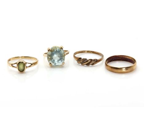 Four gold rings, comprising a 9ct gold oval mixed cut green beryl, London 1965, a 9ct gold peridot ring, a mixed cut oval per