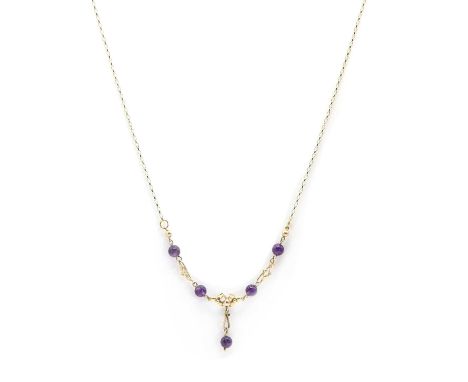 A 9ct gold amethyst necklace,the centrepiece comprising floral design links alternating to circular amethyst beads, with a sc