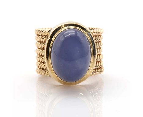 A gold blue chalcedony ring, an oval cabochon blue chalcedony, 12.05mm x 16.11mm, bezel set to a plain stepped mount, to a sh