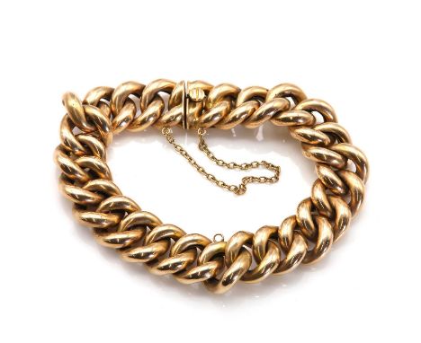 A gold curb link bracelet, with hollow curb links, 14mm wide, with a central jump ring, to a concealed box clasp and trace li