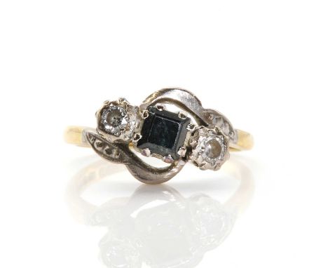 An 18ct gold three stone diamond and sapphire ring, a square cut sapphire claw set to the centre, flanked by a round brillian