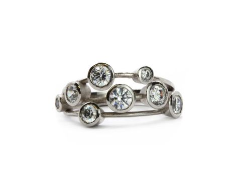 A Swarovski zirconia scatter ring,  with Swarovski cubic zirconias, rub set to scattered white metal collets to the three row