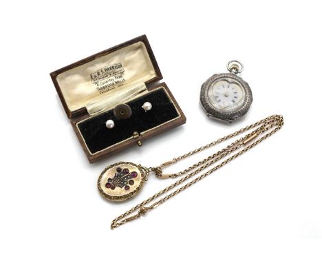 An Edwardian oval hinged back and front locket, with a palmette to the front cover, grain set with rows of graduated split pe