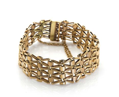 A 9ct gold bracelet,four rows of textured brick links, alternating with polished double effect links, to a sliding bar clasp,