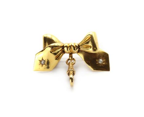 A gold split pearl bow brooch,a plain polished bow with split pearls to bow ends, star set, to pin, roller catch and swivel, 