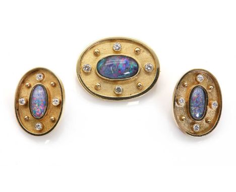 A gold diamond and opal triplet, brooch and earrings set,the brooch designed as an oval textured gold cartouche, centring a r