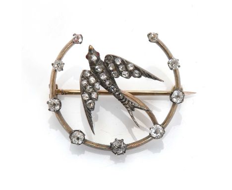 A diamond set swallow and crescent brooch,designed as a flying swallow set with rose cut diamonds and ruby eyes, to a blade e