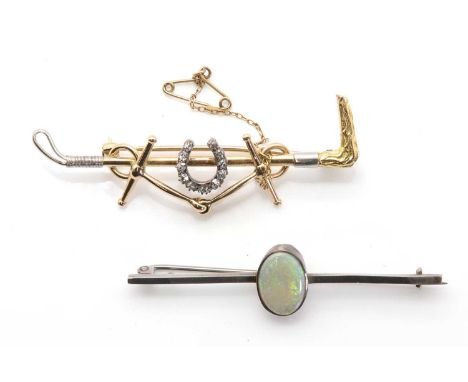 A gold and diamond equestrian brooch,the central horseshoe frame bead set with a series of old European and old eight cut dia