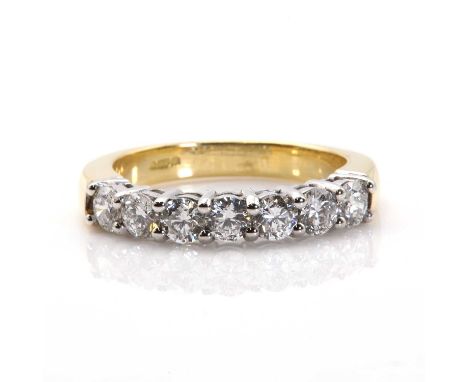 An 18ct gold diamond set half eternity ring,  with a row of seven brilliant cut diamonds, with a stated total weight of 1.07c