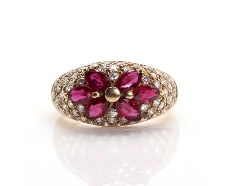 A Continental ruby and diamond bombé cluster ring,  with six marquise cut rubies, claw set to the centre. Graduated brilliant