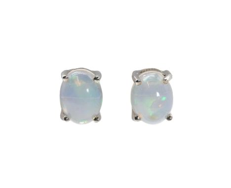 A pair of silver opal stud earrings,an oval cabochon Ethiopian opal, approximately 7.90mm x 6.01mm, claw set to post and butt