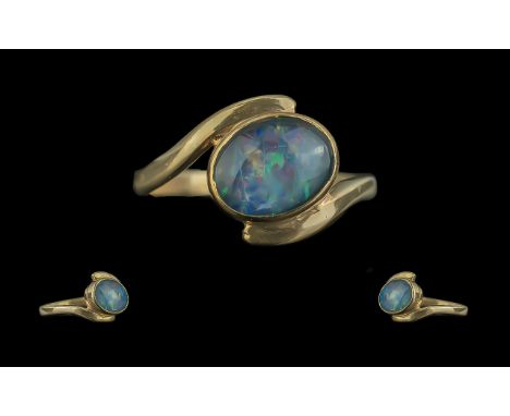 Black Opal Ring Set In 9ct Gold. Black Fire Opal Set In Yellow 9ct Gold. The Ring of Twist Design. Marked 9ct to Shank. Ring 